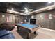 Finished basement featuring a pool table, carpeted floor, and unique wall decorations at 417 Rhodes House Dr, Suwanee, GA 30024