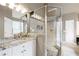 Bathroom featuring granite countertop vanity, glass enclosed shower with tile flooring and built-in storage at 417 Rhodes House Dr, Suwanee, GA 30024