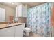 Bathroom with cabinet storage, granite countertop sink and seahorse themed shower curtain at 417 Rhodes House Dr, Suwanee, GA 30024