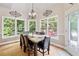 Elegant dining room with natural light, stylish chandelier, and views of backyard at 417 Rhodes House Dr, Suwanee, GA 30024