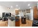 Modern kitchen with granite countertops, stainless steel appliances, and center island seating at 417 Rhodes House Dr, Suwanee, GA 30024