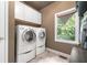 Laundry room featuring washer, dryer and natural light from the window at 417 Rhodes House Dr, Suwanee, GA 30024