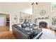 Open living area with fireplace, hardwood floors, and a large window letting in natural light at 417 Rhodes House Dr, Suwanee, GA 30024