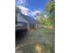 Back exterior view of the home featuring a deck, covered patio, and fenced yard at 5028 Highway 81, Mcdonough, GA 30252