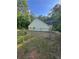 Fenced backyard featuring trees, offering privacy and space for outdoor activities at 5028 Highway 81, Mcdonough, GA 30252