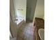 Bathroom featuring a tub, vanity and sink, tiled floor, and good lighting at 5028 Highway 81, Mcdonough, GA 30252