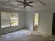Spacious main bedroom features a ceiling fan, coffered ceiling, and an ensuite bathroom at 5028 Highway 81, Mcdonough, GA 30252