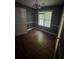 Cozy bedroom with hardwood floors and a window providing natural light at 5028 Highway 81, Mcdonough, GA 30252