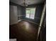 Dining room with hardwood floors, chair railing, and view of the backyard at 5028 Highway 81, Mcdonough, GA 30252