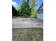 Large driveway with space for parking and views of the surrounding yard and trees at 5028 Highway 81, Mcdonough, GA 30252