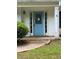 Inviting front entrance with a light blue front door, sidelights, and decorative trim at 5028 Highway 81, Mcdonough, GA 30252