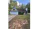 Charming one-story home featuring an attached garage and a well-maintained front yard with mature trees and shrubs at 5028 Highway 81, Mcdonough, GA 30252
