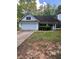 Charming one-story home featuring an attached garage and a well-maintained front yard with mature trees and shrubs at 5028 Highway 81, Mcdonough, GA 30252
