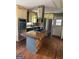 Kitchen with island, stainless steel appliances, and natural wood cabinets at 5028 Highway 81, Mcdonough, GA 30252