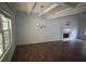 Large living room featuring hardwood floors, coffered ceiling, fireplace, and chandelier at 5028 Highway 81, Mcdonough, GA 30252