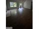Spacious living room with hardwood floors and a large window at 5028 Highway 81, Mcdonough, GA 30252