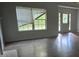 Bright living room featuring hardwood floors, large windows and a decorative glass front door at 5028 Highway 81, Mcdonough, GA 30252