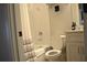 Bright white bathroom featuring a tub and shower, toilet, vanity, and neutral shower curtain at 1350 May Avenue # 14, Atlanta, GA 30316