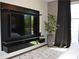 A modern bedroom with a TV on a sleek console and a large window with curtains at 1350 May Avenue # 14, Atlanta, GA 30316
