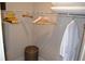 A well-organized closet with hanging clothes, shelves, and a stylish woven stool at 1350 May Avenue # 14, Atlanta, GA 30316