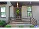 Charming front porch featuring a gray brick exterior, modern railings and well-manicured landscaping at 1350 May Avenue # 14, Atlanta, GA 30316