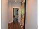 Hallway with hardwood floors and art, leading to rooms with stylish decor at 1350 May Avenue # 14, Atlanta, GA 30316