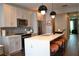 Modern kitchen featuring sleek countertops, stainless steel appliances, breakfast bar, and stylish pendant lighting at 1350 May Avenue # 14, Atlanta, GA 30316