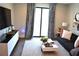 Cozy living room featuring large window, stylish curtains, comfortable sofa, and modern decor at 1350 May Avenue # 14, Atlanta, GA 30316