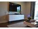 Bright living room showcasing a large screen television, stylish storage, and a modern coffee table with decor at 1350 May Avenue # 14, Atlanta, GA 30316