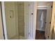 Modern bathroom shower with glass doors, tile surround, and adjacent closet at 1350 May Avenue # 14, Atlanta, GA 30316