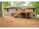 Back exterior featuring deck with stairs and light brown siding with white trim at 2445 Deerfield Nw Dr, Kennesaw, GA 30144
