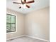 Cozy bedroom with neutral carpet, ceiling fan, and a window with a backyard view at 2445 Deerfield Nw Dr, Kennesaw, GA 30144