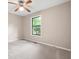 Bright bedroom with a ceiling fan, neutral paint, and a window overlooking the front yard at 2445 Deerfield Nw Dr, Kennesaw, GA 30144