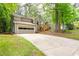 Two-story home with attached garage and freshly landscaped front yard, creating a welcoming first impression at 2445 Deerfield Nw Dr, Kennesaw, GA 30144