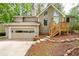 Two-story home boasts a well-manicured front yard and attached garage, offering both curb appeal and convenience at 2445 Deerfield Nw Dr, Kennesaw, GA 30144
