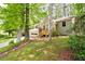 Charming home featuring a front-facing garage, a welcoming wood deck, and beautiful mature trees at 2445 Deerfield Nw Dr, Kennesaw, GA 30144
