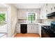 Bright kitchen with a window view, granite countertops, and modern appliances at 2445 Deerfield Nw Dr, Kennesaw, GA 30144