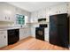 Well-lit kitchen with white cabinetry, granite counters, and black appliances at 2445 Deerfield Nw Dr, Kennesaw, GA 30144