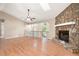 Spacious living room featuring a stone fireplace and hardwood floors, providing a comfortable and inviting atmosphere at 2445 Deerfield Nw Dr, Kennesaw, GA 30144