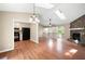 Open-concept living room with a stone fireplace, skylights, and a view into the kitchen at 2445 Deerfield Nw Dr, Kennesaw, GA 30144