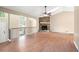 Open-concept living room with hardwood floors, a stone fireplace, and vaulted ceilings, perfect for entertaining at 2445 Deerfield Nw Dr, Kennesaw, GA 30144