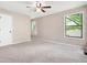 Bright, carpeted main bedroom with three windows and a ceiling fan at 2445 Deerfield Nw Dr, Kennesaw, GA 30144