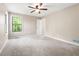 Spacious main bedroom with a window overlooking a wooded area and plush carpeting at 2445 Deerfield Nw Dr, Kennesaw, GA 30144
