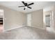 Main bedroom with plush carpet, ceiling fan and en suite bathroom at 2445 Deerfield Nw Dr, Kennesaw, GA 30144