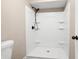 White stand up shower unit with integrated shelving and bronze shower head and fixtures at 2445 Deerfield Nw Dr, Kennesaw, GA 30144