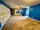This bonus room offers new carpeting, neutral walls, and ceiling fan at 325 Northmill Pkwy, Stockbridge, GA 30281