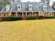 Attractive brick home featuring dormer windows, shutters, and a well-manicured front lawn at 325 Northmill Pkwy, Stockbridge, GA 30281