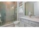 Modern bathroom with a glass-enclosed shower, sleek vanity, and contemporary fixtures with natural light at 750 Tannery Cmn, Alpharetta, GA 30009