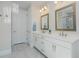 Bright bathroom featuring double vanity with white marble countertop, brushed gold fixtures, and decorative mirrors at 750 Tannery Cmn, Alpharetta, GA 30009