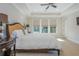 Comfortable bedroom featuring a ceiling fan, tray ceiling, and abundant natural light from the large windows at 750 Tannery Cmn, Alpharetta, GA 30009